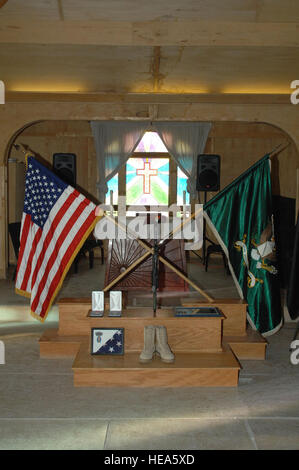 A memorial to honor Staff Sgt. Donald T. Tabb, of the 65th Military Police Company, Fort Bragg, N.C., assigned to the Combined Joint Special Operations Task Force-Afghanistan, is displayed in Fraise Chapel, at Kandahar Airfield, Afghanistan, Feb. 13. Hundreds of Soldiers, Sailors, Airmen, Marines, and coalition partners filled the chapel to pay their last respects to a fallen comrade. Tabb was killed when his vehicle struck an improvised explosive device near the village of Dab, Nahr-e Sarai District, Helmand Province, Afghanistan, Feb. 5. Stock Photo