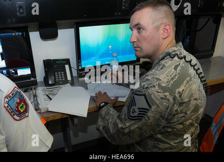 An anti-hijacking exercise conducted by the 60th Air Mobility Wing and other outside agencies played out at Travis Air Force Base, Calif., June 23, 2015.  A C-17 Globemaster played the role of the hijacked aircraft where a crew member took control trying to get to the Philippines to join the Islamic State of Iraq (ISIS). The aircraft was intercepted and turned back to Travis AFB by two Western  Air Defense Air National Guard F-15 Eagles out of Fresno, California and forced to land. After a brief negotiation process, members of the 60 Security Forces Squadron stormed the plane, neutralized the  Stock Photo