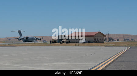 An anti-hijacking exercise conducted by the 60th Air Mobility Wing and other outside agencies played out at Travis Air Force Base, Calif., June 23, 2015.  A C-17 Globemaster played the role of the hijacked aircraft where a crew member took control trying to get to the Philippines to join the Islamic State of Iraq (ISIS). The aircraft was intercepted and turned back to Travis AFB by two Western  Air Defense Air National Guard F-15 Eagles out of Fresno, California and forced to land. After a brief negotiation process, members of the 60 Security Forces Squadron stormed the plane, neutralized the  Stock Photo