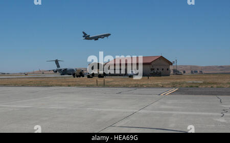 An anti-hijacking exercise conducted by the 60th Air Mobility Wing and other outside agencies played out at Travis Air Force Base, Calif., June 23, 2015.  A C-17 Globemaster played the role of the hijacked aircraft where a crew member took control trying to get to the Philippines to join the Islamic State of Iraq (ISIS). The aircraft was intercepted and turned back to Travis AFB by two Western  Air Defense Air National Guard F-15 Eagles out of Fresno, California and forced to land. After a brief negotiation process, members of the 60 Security Forces Squadron stormed the plane, neutralized the  Stock Photo