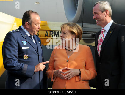 Chancellor Angela Merkel of Germany, greets Philip Murphy, U.S. ambassador to Germany, and Gen. Philip Breedlove, U.S. Air Forces in Europe and U.S. Air Forces Africa commander, during a tour of the U.S. military aircraft 'corral' at the Berlin Air Show, commonly known as ILA 2012, here Sept 11. ILA 2012 is an international event hosted by Germany and more than 50 U.S. military personnel from bases in Europe and the U.S. are here to support the various U.S. military aircraft and equipment on display. The U.S. aircraft featured at ILA 2012 are the UH-60 Black Hawk, UH-72A Lakota, F-16C Fighting Stock Photo