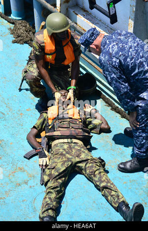 Armed Forces for the Defence of Mozambique boarding team members run through a first aid scenario during Exercise Cutlass Express 2013. Exercise Cutlass Express 2013 is a multinational maritime exercise in the waters off East Africa to improve cooperation, tactical expertise and information sharing practices among East Africa maritime forces to increase maritime safety and security in the region.  Tech. Sgt. Chad Thompson) Stock Photo