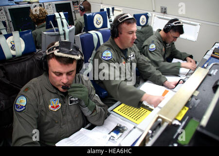 Maj. Tim Hart, Capt. Curtis Knighten and Capt. James Garza conduct air surveillance and command and control operations from an E-3 Sentry. The members of the 960th Airborne Air Control Squadron are preparing for a Christmas Eve Santa tracking mission. Airborne warning and control systems crews will provide additional surveillance as part of Operation Just Claus. Staff Sgt. Stacy Fowler) Stock Photo