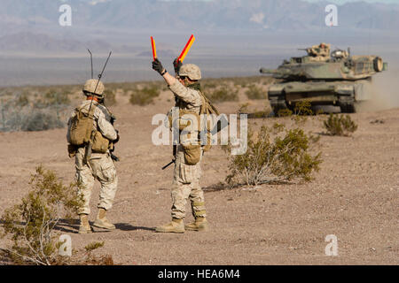 U.S. Marine engineers with 1st Battalion, 4th Marines, Camp Pendleton, Calif., direct an M1A1 Abrams tank to its objective while participating in a Brigade Assault Course training event Feb. 9, 2015, during Integrated Training Exercise 2-15 at Twentynine Palms Marine Corps Air Ground Combat Center (MCAGCC), Calif. MCAGCC conducts relevant live-fire combined arms training, urban operations, and joint/coalition level integration training that promotes operational forces' readiness.  Master Sgt. Donald R. Allen Stock Photo