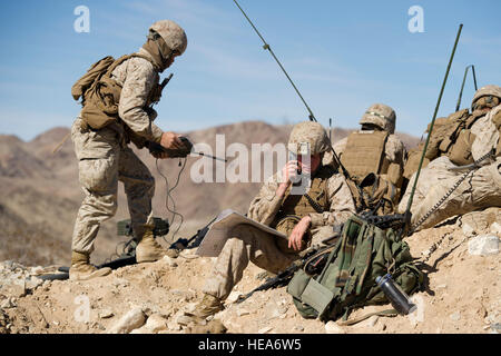 A U.S. Marine Corps fire support team, 1st Battalion, 4th Marines, Camp Pendleton, Calif., directs artillery, mortar fire and close air support while participating in a mechanized assault course event during Integrated Training Exercise 2-15 at Marine Corps Air Ground Combat Center Twentynine Palms (MCAGCC), Calif., Feb. 1, 2015. MCAGCC conducts relevant live-fire combined arms training, urban operations, and joint/coalition level integration training that promotes operational forces' readiness.  Staff Sgt. Heather Cozad Staley Stock Photo