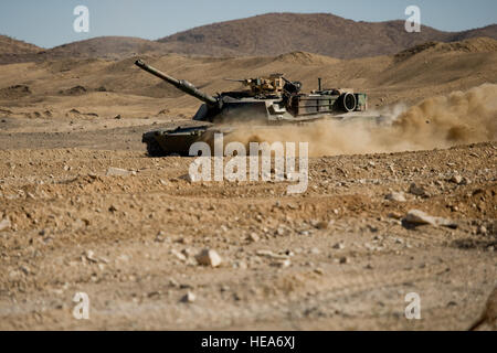 U.S. Marines operate an M1A1 Abrams tank during a mechanized assault course in support of  Integrated Training Exercise 2-15 at Marine Corps Air Ground Combat Center Twentynine Palms (MCAGCC), Calif., Feb. 4, 2015. MCAGCC conducts relevant live-fire combined arms training, urban operations, and Joint/Coalition level integration training that promotes operational forces readiness.  Staff Sgt. Amy F. Picard Stock Photo