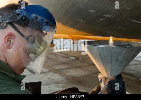 U.S. Marine Corps Lance Cpl. Dustin Moseley, crew chief, Heavy Helicopter Squadron 462, Marine Corps Air Station Miramar, Calif., takes a fuel sample from a CH-53E Super Stallion helicopter during Integrated Training Exercise 2-15 at Marine Corps Air Ground Combat Center Twentynine Palms (MCAGCC), Calif., Feb. 4, 2015. MCAGCC conducts relevant live-fire combined arms training, urban operations, and Joint/Coalition level integration training that promotes operational forces readiness.  Tech. Sgt. Matthew Smith Stock Photo