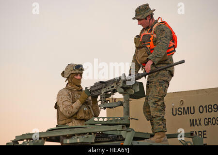 U.S. Marine Corps Lance Cpl. Richard Patterson, 1st Tank Battalion, Delta Company, performs safety checks on a .50-caliber machine gun while being evaluated by Cpl. Timothy Grottendick, Tactical Training Exercise Control Group, both located at Marine Corps Air Ground Combat Center Twentynine Palms (MCAGCC), Calif., during Integrated Training Exercise 2-15 at MCAGCC, Feb. 5, 2015. MCAGCC conducts relevant live-fire combined arms training, urban operations, and joint/coalition level integration training that promotes operational forces' readiness.  Staff Sgt. Heather Cozad Staley Stock Photo