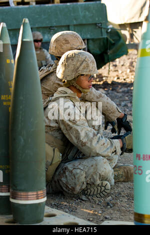 U.S. Marine Corps Pfc. Merwin Villanueva, assigned to Alpha Battery, 1st Battalion, 12th Marine Regiment, 3rd Marine Division, from Marine Corps Base Hawaii, waits to load a M777A2 lightweight 155 mm howitzer for a fire mission in support of Integrated Training Exercise 2-15 at Marine Corps Air Ground Combat Center Twentynine Palms (MCAGCC), Calif., Feb. 9, 2015. MCAGCC conducts relevant live-fire combined arms training, urban operations and joint/coalition level integration training that promotes operational forces readiness.  Staff Sgt. Amy F. Picard Stock Photo