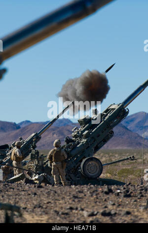 U.S. Marines assigned to Alpha Battery, 1st Battalion, 12th Marine Regiment, 3rd Marine Division, from Marine Corps Base Hawaii, fire a M777A2 lightweight 155 mm howitzer in support of Integrated Training Exercise 2-15 at Marine Corps Air Ground Combat Center Twentynine Palms (MCAGCC), Calif., Feb. 9, 2015. MCAGCC conducts relevant live-fire combined arms training, urban operations and joint/coalition level integration training that promotes operational forces readiness.  Staff Sgt. Amy F. Picard Stock Photo