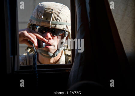 U.S. Marine Capt. Tim Agoulnik, Commander Company A, 1st Battalion, 4th Marine Regiment, Marine Corps Base Camp Pendleton, Calif., communicates on a radio while conducting Military Operations in Urban Terrain (MOUT) during Integrated Training Exercise 2-15 at Marine Corps Air Ground Combat Center (MCAGCC) Twentynine Palms Calif., Feb. 18, 2015. MCAGCC conducts relevant live-fire combined arms training, urban operations, and Joint/Coalition level integration training that promote operational forces readiness.  Staff Sgt. Kyle Brasier Stock Photo