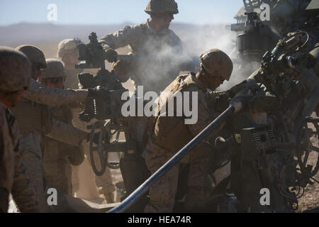 U.S. Marines assigned to Alpha Battery, 1st Battalion, 12th Marine Regiment, 3rd Marine Division, III Marine Expeditionary Force attached to 3rd Marine Regiment Force stationed out of Marine Corps Base Hawaii, load a M777A2 lightweight 155 mm howitzer for a fire mission in support of Integrated Training Exercise 2-15 at Marine Corps Air Ground Combat Center Twentynine Palms (MCAGCC), Calif., Feb. 10, 2015. MCAGCC conducts relevant live-fire combined arms training, urban operations and joint/coalition level integration training that promotes operational forces readiness.  Staff Sgt. Amy F. Pica Stock Photo