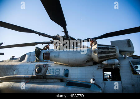 U.S. Marine maintainers and flight crew chiefs perform a preflight inspection on a CH-53E Super Stallion helicopter during Integrated Training Exercise 2-15 at Marine Corps Air Ground Combat Center Twentynine Palms (MCAGCC), Calif., Feb. 13, 2015. MCAGCC conducts relevant live-fire combined arms training, urban operations, and joint/coalition level integration training that promotes operational forces' readiness.  Tech. Sgt. Joselito Aribuabo Stock Photo