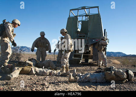 U.S. Marines assigned to 1st Marine Logistics Group, Marine Corps Base Camp Pendleton, evaluate casualties while participating in a mock battlefield scenario during Integrated Training Exercise 2-15 at Marine Corps Air Ground Combat Center (MCAGCC) Twentynine Palms, Calif., Feb. 15, 2015. MCAGCC conducts relevant live-fire combined arms training, urban operations, and joint/coalition level integration training that promote operational forces' readiness.  Tech. Sgt. Efren Lopez Stock Photo