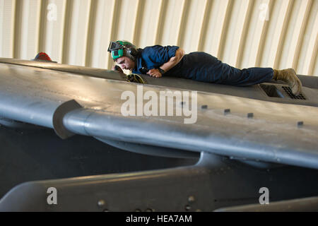 U.S. Marine Lance Cpl. Daniel Broome, a seat mechanics assigned to Marine Attack Squadron 214 'Black Sheep,' Marine Corps Air Station Yuma, Ariz., services an AV-8B Harrier during Integrated Training Exercise 2-15 at Marine Corps Air Ground Combat Center (MCAGCC) Twentynine Palms, Calif., Feb. 17, 2015. MCAGCC conducts relevant live-fire combined arms training, urban operations, and joint/coalition level integration training that promote operational forces readiness.  Tech. Sgt. Efren Lopez Stock Photo