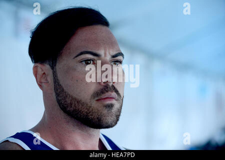 U.S. Navy Retired Navy Electrician’s Mate 3rd Class Michael Roggio of Team U.S. stands on the pool deck during the swimming finals for the Invictus Games 2016 in Orlando, Fla. May 11, 2016. The Invictus Games are composed of 14 nations, over 500 military competitors, competing in 10 sporting events May 8-12, 2016.  Staff Sgt. Carlin Leslie Stock Photo