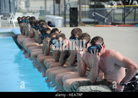 Members of the 334th Training Squadron combat controllers and the 335th Training Squadron special operations weather team prepare to enter the triangle pool as they participate in a memorial physical training session Sept. 26, 2014, at Keesler Air Force Base, Miss. The session included a ruck march along the Ocean Springs Beach and over the Biloxi-Ocean Springs Bridge. The PT event was in memory of combat controllers Senior Airman Mark Forester, who was killed in action Sept. 29, 2010, and Senior Airman Daniel Sanchez, who was KIA Sept. 16, 2010. Kemberly Groue) Stock Photo