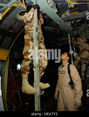 U.S. Air Force Staff Sgt. Phillip Hines, aero-medical evacuation instructor, ensures an Iraqi air force medic reconfigures a C130 Hercules aircraft correctly for patient transport during a patient movement exercise at New Al-Muthana Air Base, Iraq, on Dec. 3. Hines, a Kaiserslautern, Germany native, is deployed from the USAF School of Aerospace Medicine in San Antonio, Texas. Stock Photo