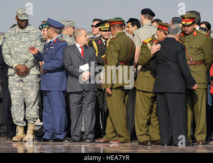 U.S. Army General Lloyd J. Austin III, U.S. Forces - Iraq commanding general, converses with Pilot Lt. Gen Ahmed Anwar, Iraqi Air Force commander Jan. 6, 2011, before the start of the ceremony of the Iraqi Army Day Parade in Baghdad, Iraq.  Senior Airman Andrew Lee) Stock Photo