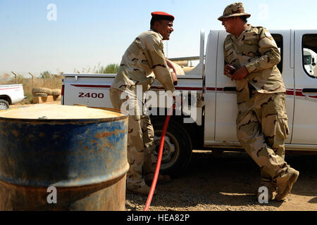 Iraqi soldiers refuel a vehicle at Camp Taji, near Baghdad, Iraq, July 11. The Iraqi fuels depot is run exclusively by the Iraqi army with some assistance from an American Airman assigned to the Logistics Military Advisor Team. Stock Photo