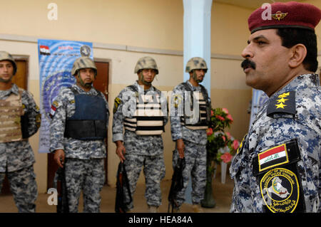 Iraqi national police from the Justice Battalion, 3rd National Police Division, hear a few words from their commander, Col. Jab Abid Awn, before receiving their air assault wings after participating in a joint air assault with U.S. Soldiers from Blackhorse Troop, 1st Squadron, 32nd Cavalry, 101st Airborne Division on Forward Operating Base Paliwoda, Iraq, Sept. 20, 2008. Stock Photo
