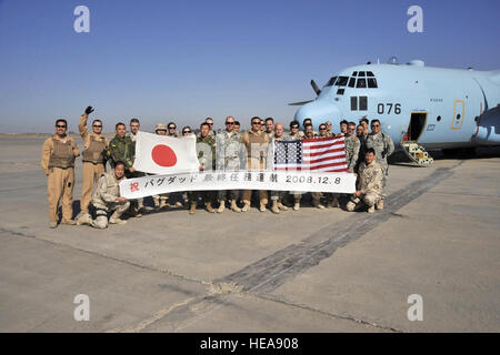 12/08/2008 - SATHER AIR BASE, Iraq - Japanese Air Self-Defense Force and 447th Air Expeditionary Group Airmen pose for one last photo together Dec. 8 on the flightline at Sather Air Base on the west side of Baghdad International Airport. After the photo was taken, the Japanese C-130 Herculese transport aircraft made its final departure from Iraq, concluding the Japanese military mission in Iraq.  Master Sgt. Brian Davidson) Stock Photo