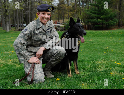 Staff Sgt. Samantha Navarrete, 11th Security Support Flight military working dog handler sits with her dog Besy, a recipient of the 2012 K9 Medal for Exceptional Service Award during a ceremony April 19, 2013, at Joint Base Andrews, Md. Besy was one of only two military working dogs honored in 2012 for demonstrating exceptional acts in the War on Terror. This is the first time an Air Force team has received this award.  Airman 1st Class Nesha Humes)(Released) Stock Photo