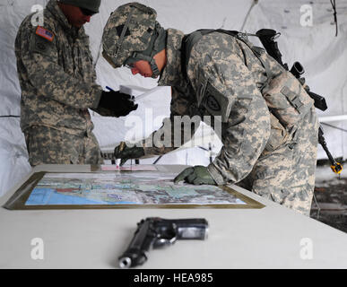 Parachute infantryman 1st Lt. Patrick Nguyen, a native of Houston, Texas, assigned to Headquarters and Headquarters Company 1st Battalion (Airborne) 501st Infantry Regiment, identifies terrain features on a map during the Expert Infantryman Badge qualification on Joint Base Elmendorf-Richardson, Alaska, April 24, 2013. The Expert Infantryman Badge was approved by the Secretary of War Oct. 7, 1943, and is currently awarded to U.S. Army personnel who hold infantry or special forces military occupational specialties. Justin Connaher) Stock Photo