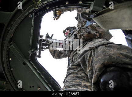 Parachute infantryman 1st Lt. Patrick Nguyen, a native of Houston, Texas, assigned to Headquarters and Headquarters Company 1st Battalion (Airborne) 501st Infantry Regiment, loads a M2-HB .50 Cal. machine gun during the Expert Infantryman Badge qualification on Joint Base Elmendorf-Richardson, Alaska, April 24, 2013. The Expert Infantryman Badge was approved by the Secretary of War Oct. 7, 1943, and is currently awarded to U.S. Army personnel who hold infantry or special forces military occupational specialties. Justin Connaher) Stock Photo