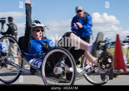 Kristina Morin, a 2015 Air Force Wounded Warrior cycling competitor, crosses the finish line of the woman's recumbent race at Nellis Air Force Base, Nev. Feb. 28, 2015. The recumbent race is one of the three cycling events the warrior athletes competed in. The Air Force Trials are an adaptive sports event designed to promote the mental and physical well-being of seriously ill and injured military members and veterans. More than 105 wounded, ill or injured service men and women from around the country will compete for a spot on the 2015 U.S. Air Force Wounded Warrior Team which will represent t Stock Photo