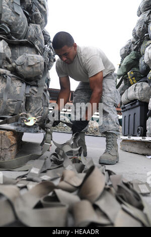 Airman 1st Class Heriberto Dominguez, air transportation journeyman deployed with the 376th Expeditionary Logistics Readiness Squadron as a passenger service agent, connects cargo straps onto pallets for transportation onto a C-17 Globemaster III on Aug. 6, 2010, at the Transit Center at Manas, Kyrgyzstan. With the nickname 'Yard Dogs,' he assists in building an upward of 15 pallets a day taking about 10 minutes per pallet. (U.S. Air Force Photo/Staff Sgt. Nathan Bevier) Stock Photo