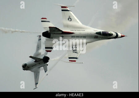 Maj's. Blaine Jones, Thunderbird 5, Lead Solo and Jason Curtis, Thunderbird 6, Opposing Solo, perform the Crossover Break maneuver during the practice demonstration at Joint Base McGuire-Dix-Lakehurst, N.J., May 9, 2014. Staff Sgt. Larry E. Reid Jr.) Stock Photo