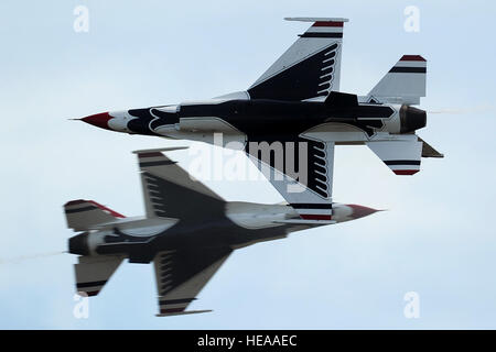 U.S. Air Force Maj's. Blaine Jones, Thunderbird 5, lead solo, and Jason Curtis, Thunderbird 6, opposing solo, perform the Inverted Opposing Knife-Edge Pass during the Joint Base McGuire-Dix-Lakehurst Open House, May 11, 2014. (U.S. Air Force photo Staff Sgt. Larry E. Reid Jr., Released) Stock Photo