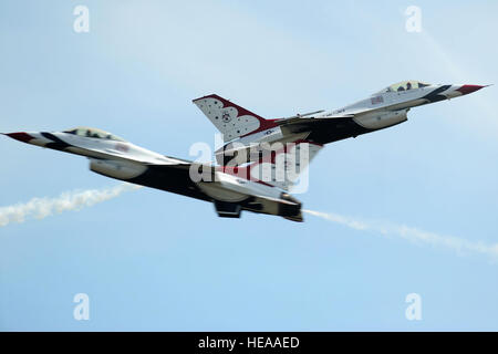 Maj's. Blaine Jones, Thunderbird 5, Lead Solo and Jason Curtis, Thunderbird 6, Opposing Solo, cross at show-center performing the Split-S maneuver during the Joint Base McGuire-Dix-Lakehurst Open House, May 11, 2014. Staff Sgt. Larry E. Reid Jr.) Stock Photo