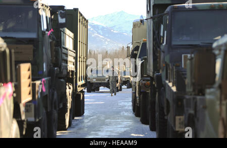 Army Spc. David Klier, a native of, Los Angeles, assigned to the 4th Infantry Brigade Combat Team (Airborne), 25th Infantry Division, U.S. Army Alaska, ground guides vehicles into a marshalling yard before their transport to the port of Anchorage and follow on movement to the Joint Readiness Training Center at Fort Polk, La., on Joint Base Elmendorf-Richardson, Alaska, Feb. 24, 2014.  Justin Connaher Stock Photo