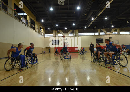 Charlie Walker, a 2015 Help for Heroes wheelchair basketball competitor, takes a shot during the Air Force Wounded Warrior Trials on Nellis Air Force Base, Nev., March 1, 2015. The Air Force Trials are an adaptive sports event designed to promote the mental and physical well-being of seriously ill and injured military members and veterans. More than 105 wounded, ill or injured service men and women from around the country will compete for a spot on the 2015 U.S. Air Force Wounded Warrior Team which will represent the Air Force at adaptive sports competitions throughout the year.  Senior Airman Stock Photo