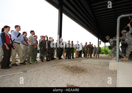 Civilians and military members from Mexico, United Kingdom, Italy, Portugal and France observe U.S. Army soldiers from the 82nd Airborne Division practice parachute landing falls during a Joint Operation Access Exercise, Fort Bragg, N.C., June 24, 2013. Joint Operational Access Exercise is a seven day integrated effort between the 82nd Airborne Division and its Air Force partners. JOAX synchronizes the planning  and execution of a large-scale forcible entry into a hostile area; securing sufficient freedom of movement while facing anti-access and area-denial capabilities of our enemy. This unif Stock Photo