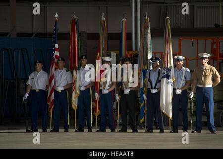 A joint service color guard team prepares to present the colors during the Joint POW/MIA Accounting Command arrival ceremony Dec. 9, at Joint Base Pearl Harbor-Hickam, Hawaii. Arrival ceremonies are held in honor of the sacrifices made by the individuals whose unidentified remains were recovered during JPAC recovery missions. Stock Photo