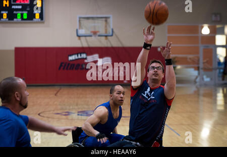 Charlie Walker, a Help for Heroes athlete, shoots a basketball during the 2015 Air Force Wounded Warrior Trials on Nellis Air Force Base, Nev., March 1, 2015. The Air Force Trials are an adaptive sports event designed to promote the mental and physical well-being of seriously ill and injured military members and veterans. More than 105 wounded, ill or injured service men and women from around the country will compete for a spot on the 2015 U.S. Air Force Wounded Warrior Team which will represent the Air Force at adaptive sports competitions throughout the year.  Senior Airman Jordan Castelan Stock Photo