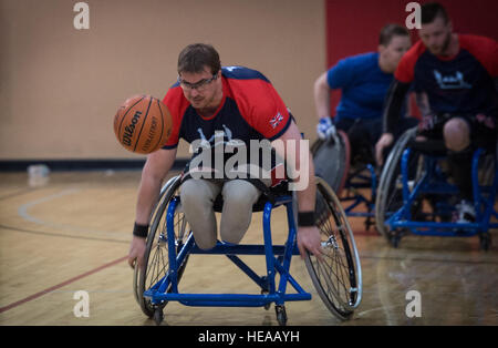 Charlie Walker, a Help for Heroes athlete, chases a basketball during the 2015 Air Force Wounded Warrior Trials on Nellis Air Force Base, Nev., March 1, 2015. The Air Force Trials are an adaptive sports event designed to promote the mental and physical well-being of seriously ill and injured military members and veterans. More than 105 wounded, ill or injured service men and women from around the country will compete for a spot on the 2015 U.S. Air Force Wounded Warrior Team which will represent the Air Force at adaptive sports competitions throughout the year.  Senior Airman Jordan Castelan Stock Photo