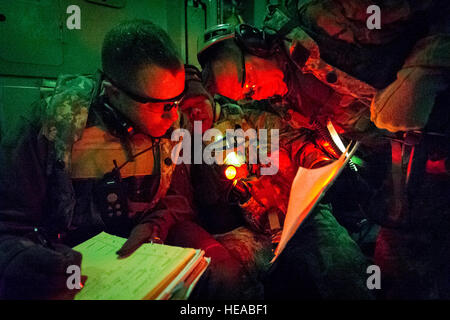 From left, U.S. Air Force Majs. Corey Norton, flight nurse, 43rd Aeromedical Evacuation Squadron, Pope Army Airfield, N.C., Sam Chhoeun, clinical nurse, 375th Medical Group, Scott Air Force Base, Ill., and U.S. Air Force Lt. Col. Gerald Fortuna, trauma surgeon, 86th Medical Group, Ramstein Air Base, Germany, review patient details before aeromedical evacuation at Joint Readiness Training Center (JRTC), Fort Polk, La., Jan. 18, 2014. Service members at JRTC 14-03 are educated in combat patient care and aeromedical evacuation in a simulated combat environment.  Master Sgt. John R. Nimmo, Sr./) Stock Photo