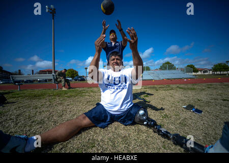 Retired U.S. Army Staff Sgt. Roy Rodriguez, a Special Operations Forces athlete, tosses the medicine ball to Richard Roberts, seated throws coach, during the 2015 USSOCOM All Sports Camp, Feb. 23 at MacDill Air Force Base, Fla. Rodriguez, a native of Kentucky, is a second-time participant who is competing in archery, discus throw and cycling.  (U.S.  Tech. Sgt. Angelita M. Lawrence) Stock Photo