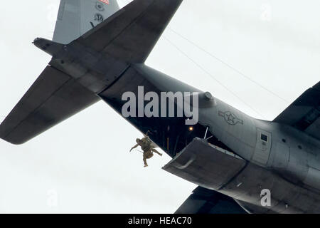 A 31st Rescue Squadron pararescueman jumps out of a 36th Airlift Squadron C-130 Hercules during a training mission over Yokota Air Base, Japan, Jan. 6, 2015. The 36th Airlift Squadron and 31st Rescue Squadron maintain mission readiness for aircrew and pararescuemen.  Osakabe Yasuo Stock Photo