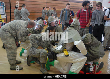 U.S. Airmen from the 18th Aerospace Medicine Squadron combine several medical specialties to simulate conditions during a chemical threat during the Kadena High School Career Day on Kadena Air Base, Japan, April 4, 2013. Hosted by the Air Force Cadet Officer Mentor Action Program, the purpose of the event was to offer a glimpse of Airmen's daily duties to possible recruits.  Staff Sergeant Lauren Snyder Stock Photo