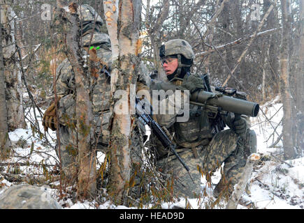 Paratroopers assigned to the 3rd Battalion, 509th Parachute Infantry Regiment, 4th Infantry Brigade Combat Team (Airborne) 25th Infantry Division, U.S. Army Alaska, maneuver past the wooded region during a live-fire and movement-to-contact operations on the Infantry Squad Battle Course at Joint Base Elmendorf-Richardson, Alaska, Tuesday, Nov. 8, 2016. The soldiers focused on core infantry skills such as fire team movement, communication, shifting fire, and once on the objective identifying and eliminating weapons caches and treating and evacuating casualties.  Airman 1st Class Javier Alvarez) Stock Photo