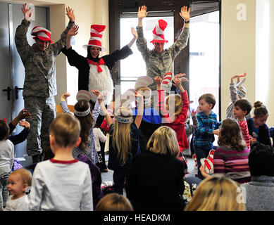 Chief Master Sgt. Steven Mandell, (left), 86th Force Support Squadron superintendent, Alison McKee, 86th FSS librarian, and Lt. Col. Thomas Ausherman, (right), 86th FSS commander, lead children through a song and dance during Read Across America, March 5, 2015, at Ramstein Air Base, Germany. The event consisted of story time, snacks and free books for the children. Airman 1st Class Larissa Greatwood) Stock Photo