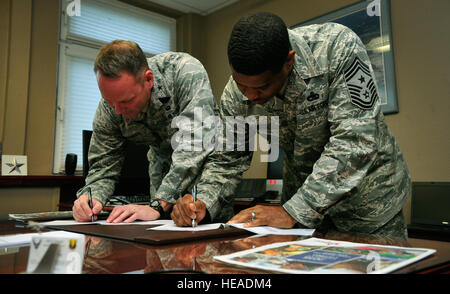 Brig. Gen. Jon T. Thomas, 86th Airlift Wing commander, and Chief Master Sgt. Phillip Easton, 86th AW command chief, sign pledge forms in support of the Combined Federal Campaign-Overseas Oct. 22, 2015, at Ramstein Air Base, Germany. The CFC-O allows U.S. military members and U.S. government civilian employees to donate to the charity of their choice, with more than 2,600 charities available to choose from. Airman 1st Class Larissa Greatwood) Stock Photo