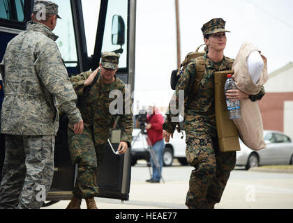 U.S. Marines disembark a coach bus upon arrival at the Langley Transit Center at Langley Air Force Base, Va., Nov. 13, 2014. Ninety U.S. military personnel from the Air Force, Army, Marine Corps and Navy will undergo a mandatory 21-day controlled monitoring period at the transit center, where they will be separated from the general public in order to be monitored for and deemed clear of any symptoms consistent with the Ebola virus disease.  Staff Sgt. Jason J. Brown Stock Photo