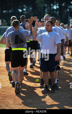 U.S. Army soldiers and U.S. Air Force airmen high-five each other after finishing a softball game against one another during the 20th Mission Support Group Warrior Challenge, Shaw Air Force Base, S.C., Sept. 6, 2013. The 20th MSG Warrior Challenge, a day-long event meant to boost morale between airmen and soldiers, included softball, tug of war, a watermelon eating contest and other events to build camaraderie.   Airman 1st Class Jensen Stidham Stock Photo
