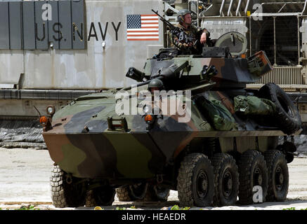 US Marine Corps (USMC) Marines drive their Light Armored Vehicle (LAV-25) along the beach at Samesan Royal Thai Marine Base, Thailand, after offloading from a US Navy (USN) Landing Craft-Air Cushion (LCAC) craft, during an amphibious assault exercise conducted during Exercise COBRA GOLD 2002. Stock Photo